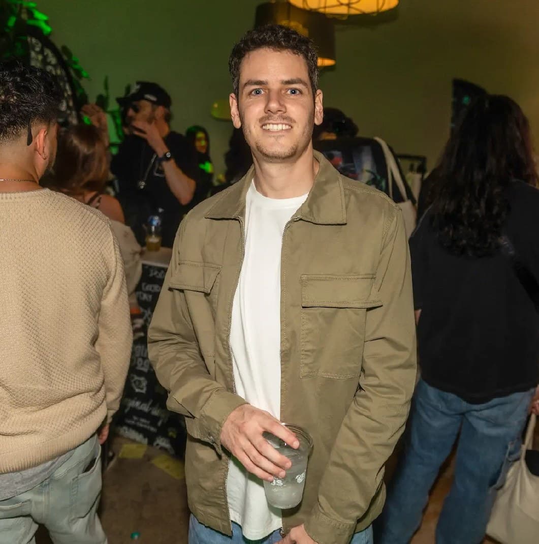 Hayden Harris — GambitMeta Hayden Harris, publicly known as Gambit and GambitMeta (@gambitmeta), in an olive jacket and white shirt at an indoor gathering